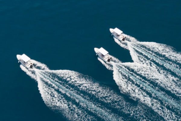 Video: Three rental boats cruising fast in open sea (drone view)